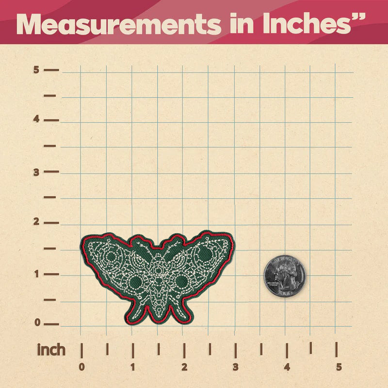 A KosmicSoul Butterfly Moth Patch measuring in inches on a ruler with sewn on buttons.