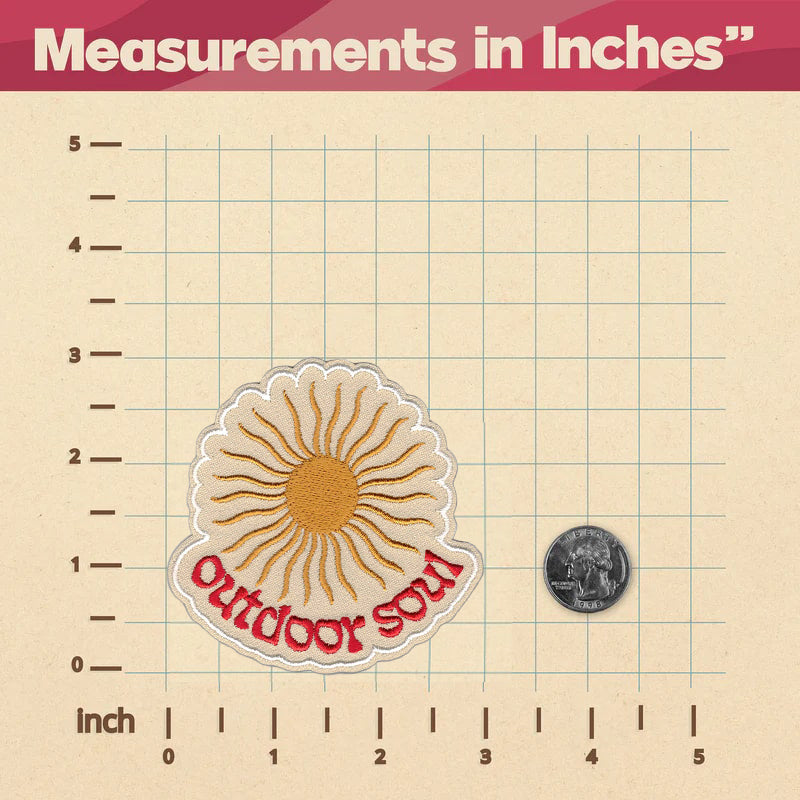 An Outdoor Soul Patch ruler with measurements in inches, labeled with a sticker ironed on it by KosmicSoul.