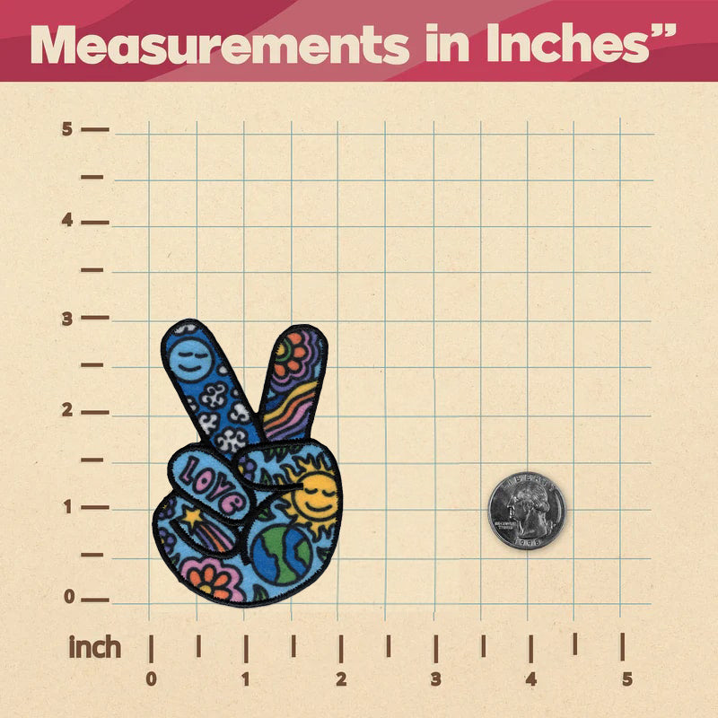 A Peace Sign Patch measuring in inches on a ruler, ironed on.