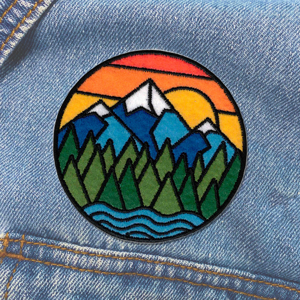 A colorful Mountain Sunset Patch with a mountain scene sewn on it by KosmicSoul.