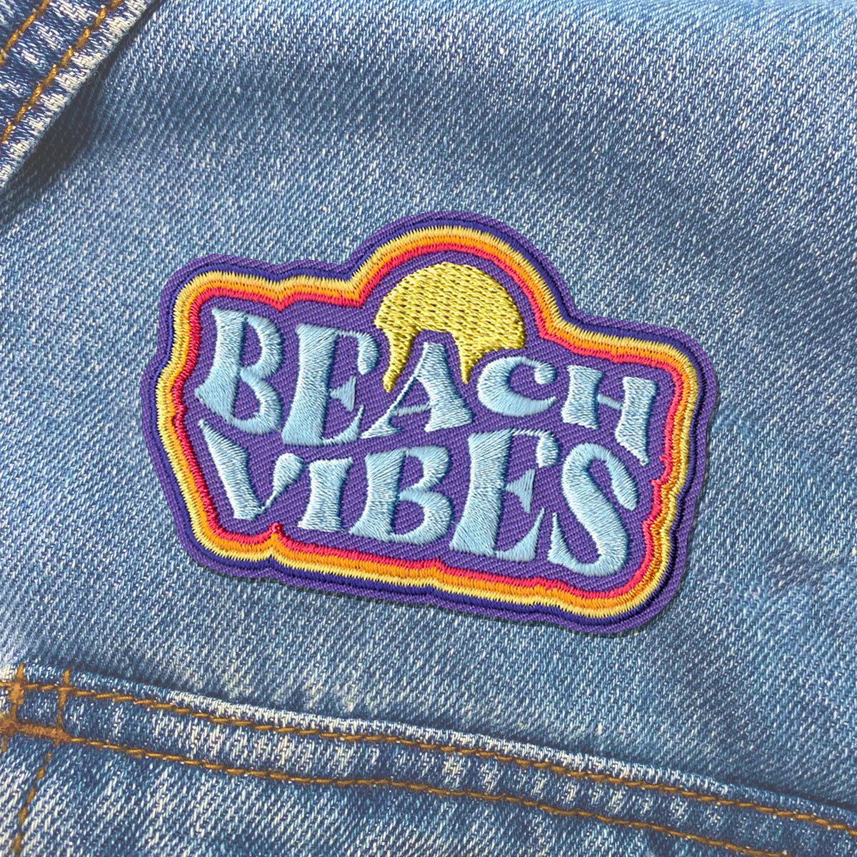 KosmicSoul Beach Vibes patch sewn on a denim jacket.