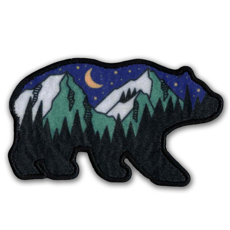 A KosmicSoul Outdoor Bear Patch with sewn on moon and stars.