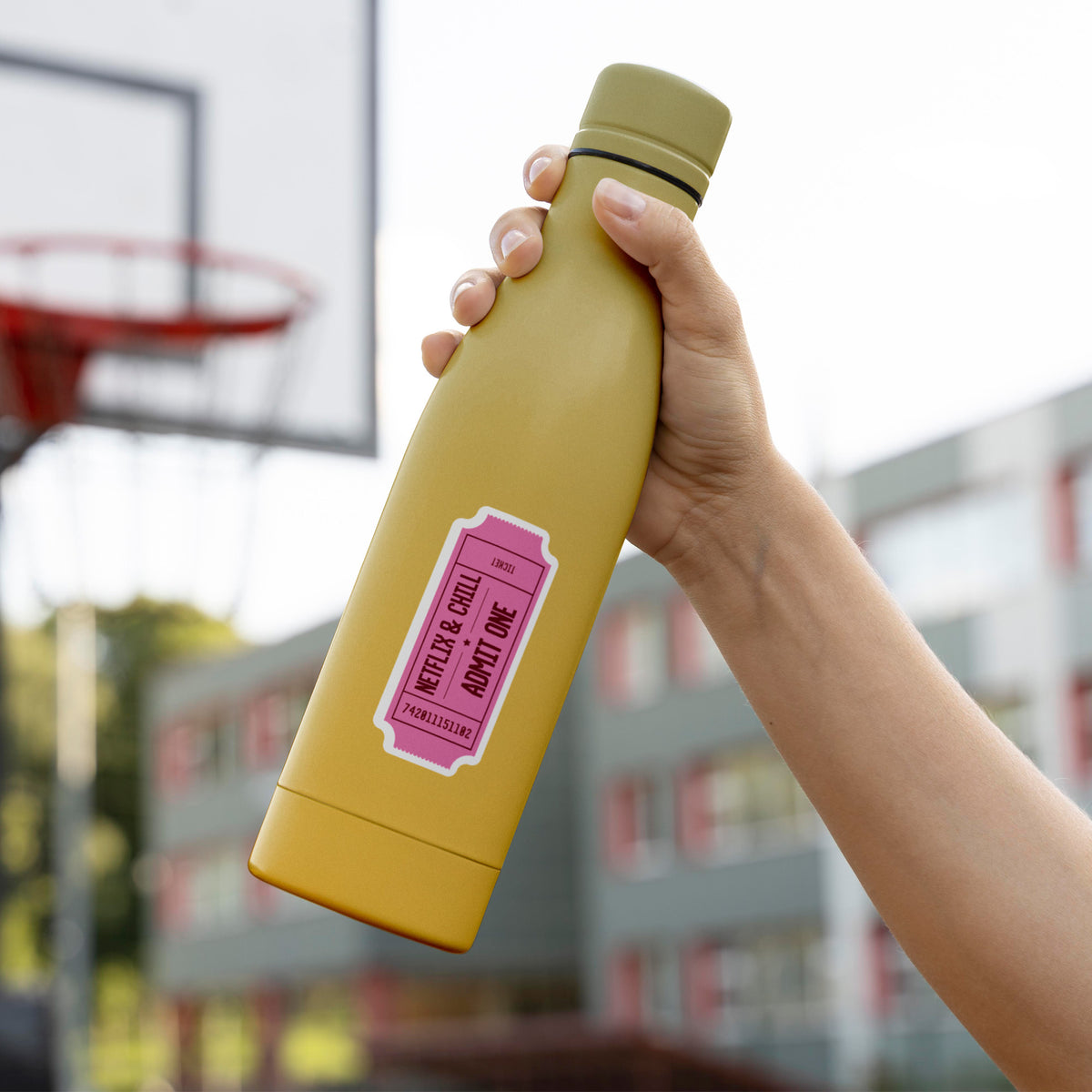 A person finishing a KosmicSoul Netflix &amp; Chill Sticker in front of a basketball court.