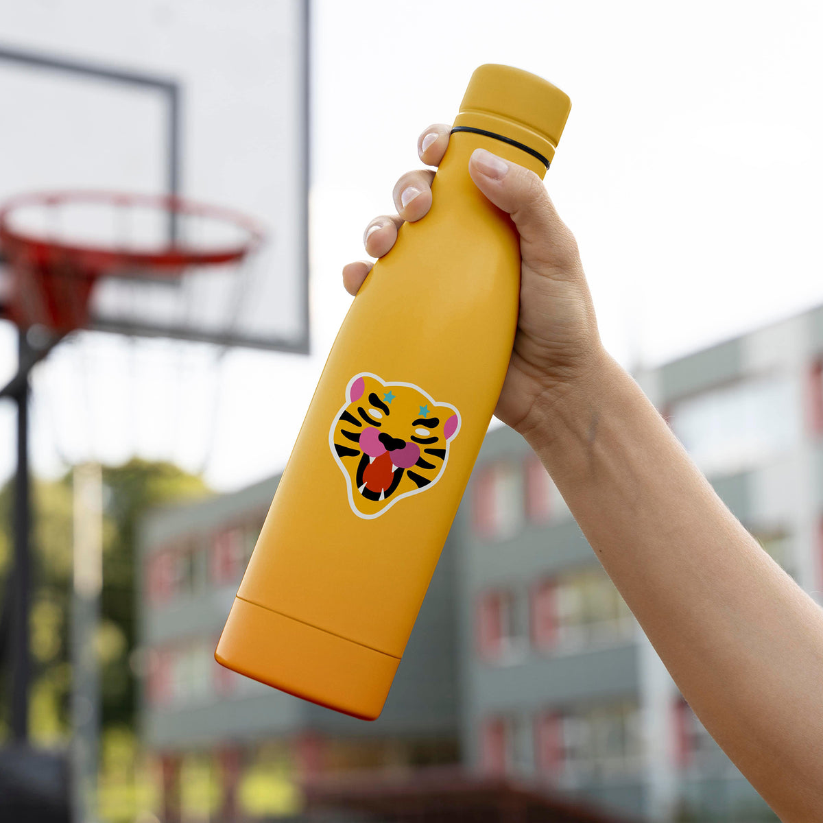 A person holding a yellow KosmicSoul Tiger Sticker water bottle with a matte finish and dimensions.